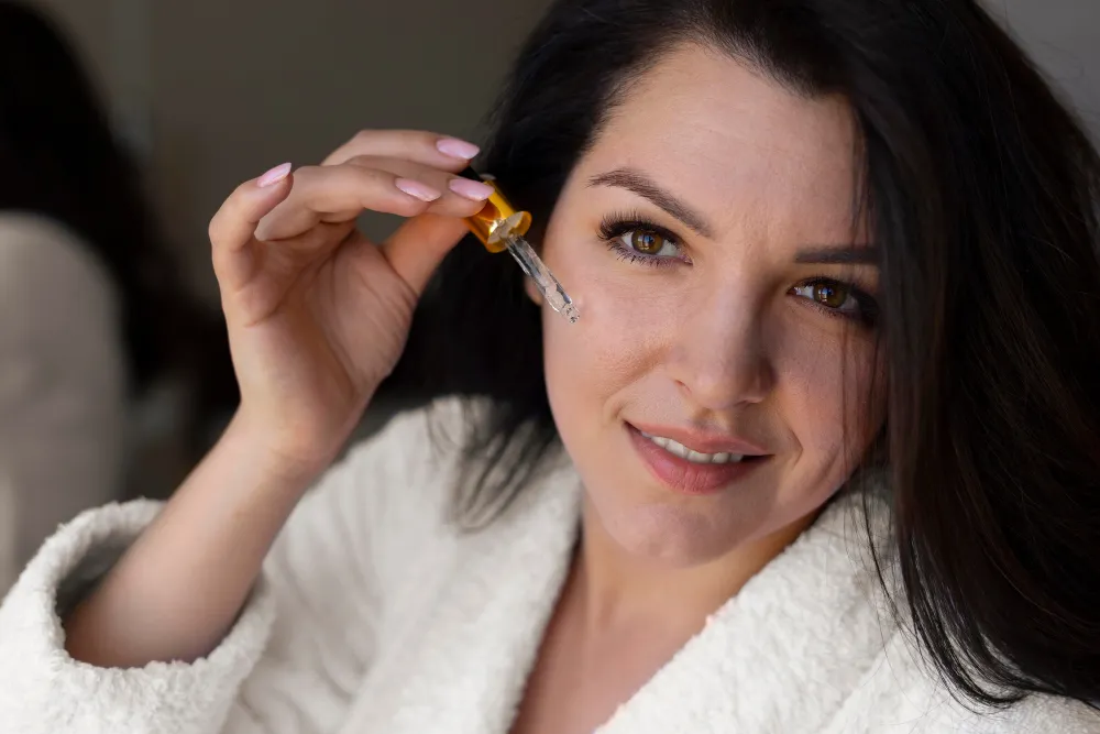close-up-woman-applying-face-serum-2